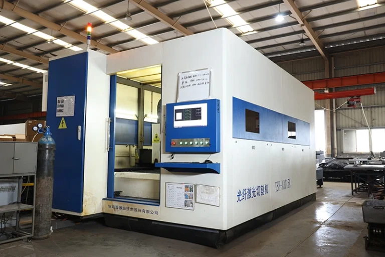 Flat laser cutting machine slicing steel sheet inside the Wanhoo three wheeler factory