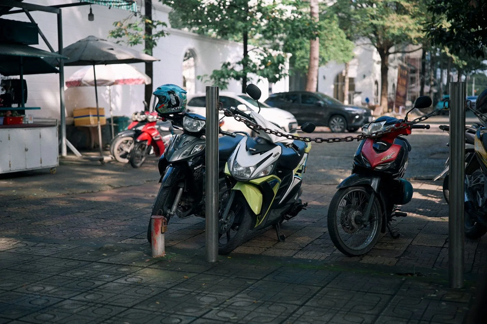 Stock photograph of several motorcycles parked together beside a road; the motorcycles and location are unaffiliated with Wanhoo