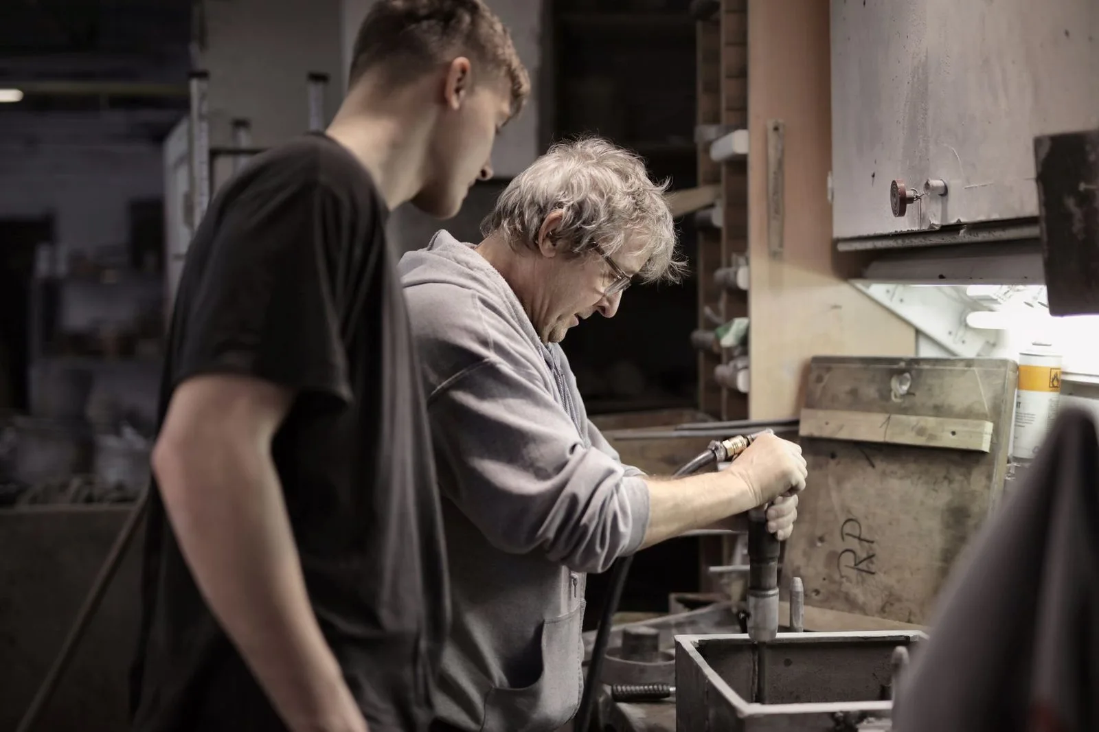 Pexels stock photograph by Andrea Piacquadio, unaffiliated with Wanhoo, showing an experienced worker teaching an apprentice