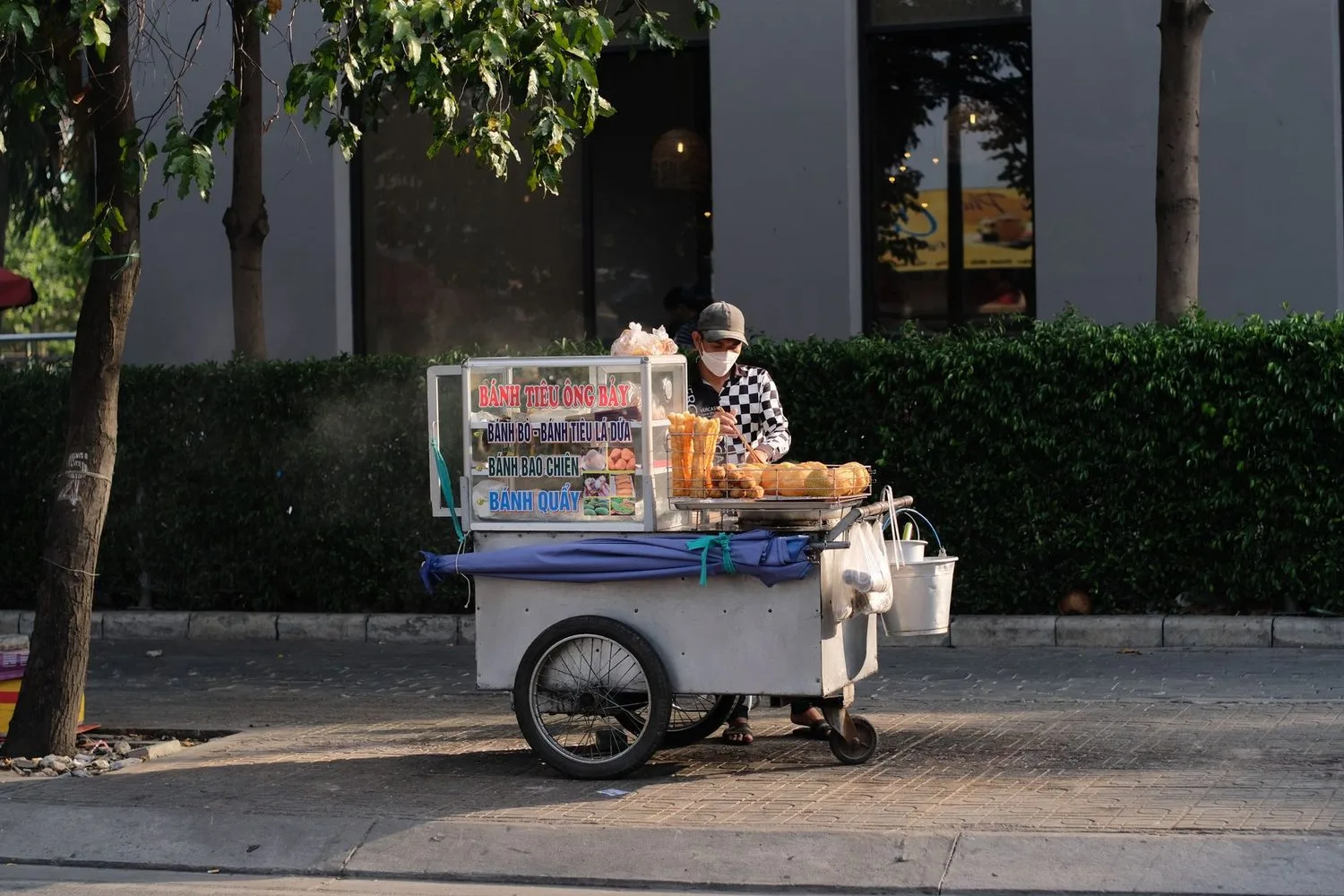 Stock photograph, unaffiliated with Wanhoo: a street vendor selling from a cart, the vehicle serving as the shop itself